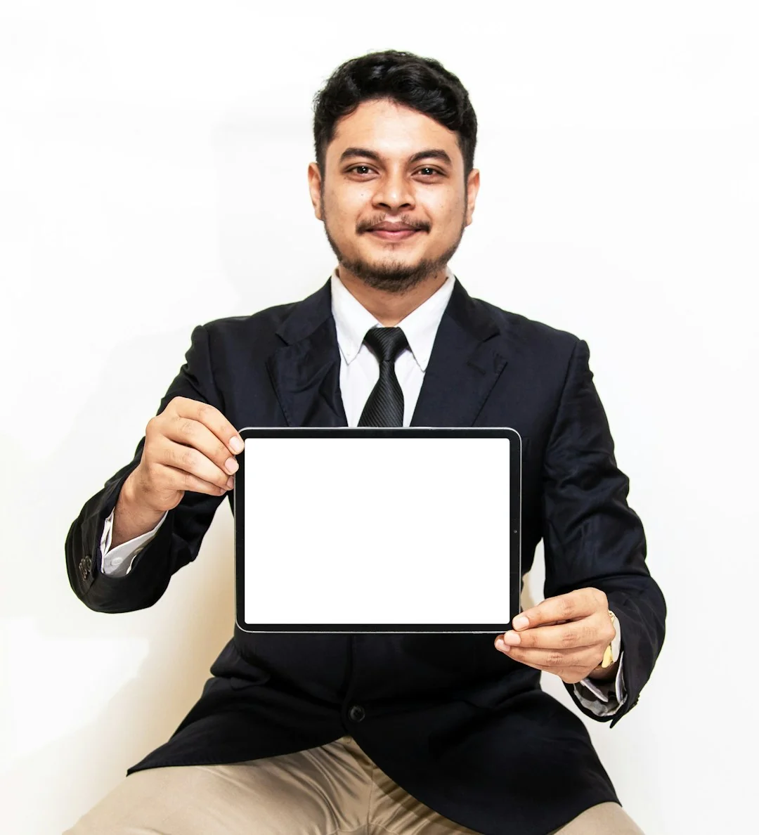 A tablet with a financial website open, alongside a white keyboard and mouse. Ideal for tech-theme stock images.